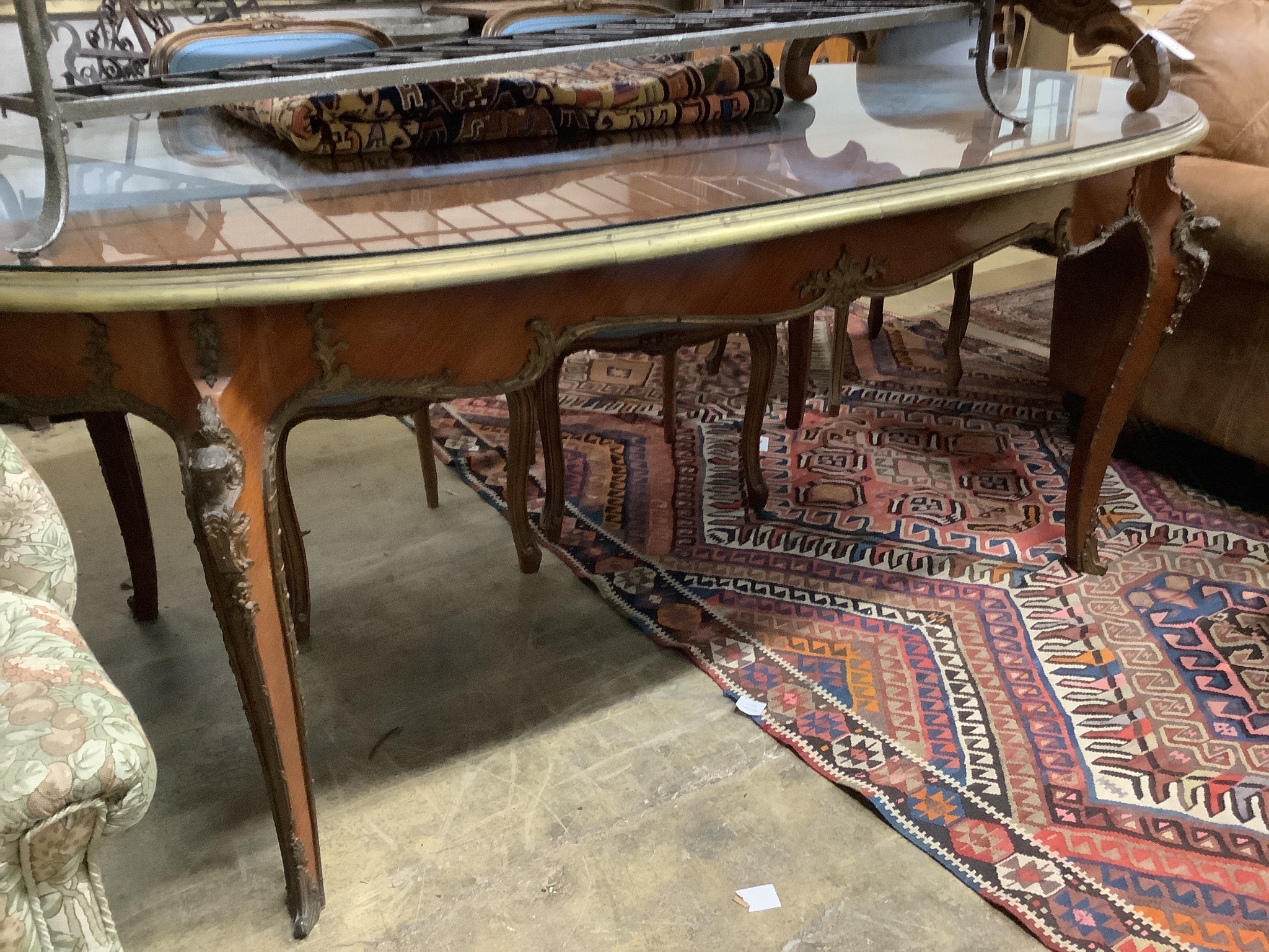 An oval gilt metal mounted Continental dining table, length 200cm, width 100cm, height 78cm